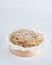 Baked mini crumble cake on recycle Mini Wooden Baking Mold, white background, copy space, selective focus. Homemade pastry,