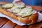 Baked in the oven sandwich with cheese, sausage and cucumbers. crispy bun and juicy filling, street food, fast food, snack on the