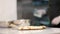 Baked pastry lying on kitchen table with blurred male chef working at background. Unrecognizable Caucasian cook