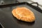 Baked pasty hot out of the oven on a baking tray