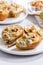 Baked pears with blue cheese, walnuts and honey on white plate and light background