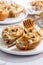 Baked pears with blue cheese, walnuts and honey on white plate and light background