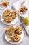 Baked pears with blue cheese, walnuts and honey on white plate and light background