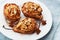 Baked pears with ricotta, walnuts, honey and cinnamon in a white plate on blue background. Delicious autumn dessert.