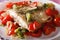 Baked plaice with peppers and broccoli close-up. horizontal