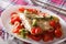 Baked plaice with seasonal vegetables close-up on a plate