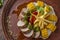 Baked pork served with french fries, corn and pesto, restaurant platter, Horizontal orientation, Top view