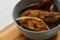 Baked potato and rosemary wedges in a grey bowl