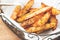 Baked potato wedges on basket - homemade organic vegetable, vegan potato wedges snack food