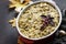 Baked potatoes with mushrooms, sour cream and cheese on a brown stone or slate background.