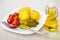 Baked potatoes with pickled tomatoes, gherkins, fork in plate