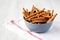 Baked Pretzel Sesame Sticks in a Bowl, low angle view. Space for text