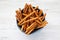 Baked Pretzel Sesame Sticks in a Bowl on a white wooden background, top view. Flat lay, overhead, from above