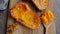 Baked pumpkin on a wooden surface, top view. Close up