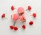 Baked red strawberry macarons and rosebuds on a white table, gourmet almond flour dessert