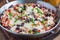 Baked rice casserole with black beans, pinto beans, kidney beans, cheese and paprika, in a metal baking dish, horizontal, closeup