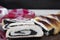 Baked roll with poppy seeds, three chopped pieces close-up on a black background with a red and white cloth.