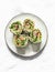 Baked salmon, avocado puree, green  salad tortilla wrapped roll sandwich on a light background, top view