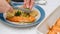 Baked salmon, cauliflower and broccoli casserole served close up on a plate.