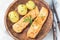 Baked salmon in creamy sauce with young boiled  potato topped with melted butter and chopped dill on  wooden plate, horizontal,