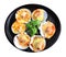 Baked Scallops with Cheese and green Parsley black ceramic dish isolated on white background with clipping path. Grill seashell