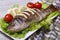 Baked sea bass with lemon on a plate with lettuce