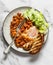 Baked shakshuka with tomato sauce beans and iceberg salad is a delicious healthy breakfast on a light background. top view