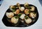 Baked snails with butter and herbs.