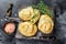 Baked Spanakopita spiral filo pastry puff pie with feta cheese and spinach. Black background. Top view