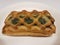 Baked spinach pastry on white plate on table