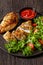 Baked Split Chicken Breasts with salad on plate
