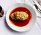 Baked stuffed eggplant served with spicy tomato sauce