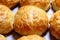 Baked sweet buns on a baking sheet with a ruddy crust, homemade delicious cakes