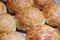 Baked sweet buns on a baking sheet with a ruddy crust, homemade delicious cakes