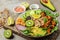 Baked tofu bowl with avocado, chickpeas, cucumber and mushrooms, buddha bowl. Vegan lunch salad, Food recipe background. Close up