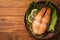 Baked trout steak in pottery with salad and slices of lemon