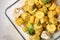 Baked yellow carrot with broccoli and cauliflowers in glass dish on table, top view