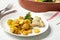 Baked yellow carrot with broccoli and cauliflowers on white table, closeup