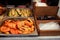 Baked yellow peppers in the foreground and green zucchini in the background in square containers