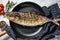 Baked Yellowtail, Japanese amberjack in a pan. Gray background. Top view