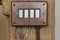Bakelite toggle light switch in brown on wooden pole