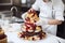 A baker assembling layers of a multi-tiered wedding cake, showcasing expertise in creating stunning confections. Generative AI