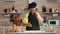 Baker claps her hands with flour over the table