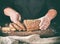 baker cuts a knife into slices of rye bread with pumpkin seeds