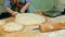 A baker is cutting dough