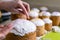 Baker decorates Easter cakes with sugar icing