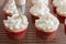 Baker decorates muffins with cream and confectionery nozzles