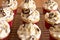 Baker decorates muffins with cream and confectionery nozzles