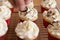 Baker decorates muffins with cream and confectionery nozzles