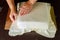 Baker decorating square cake with white fondant